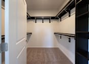 Thumbnail 32 of 44 - a walk in closet with empty shelves and empty belts at The Clearing at ONE28, Olathe, Kansas