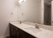 Thumbnail 36 of 44 - a bathroom with two sinks and a large mirror at The Clearing at ONE28, Olathe, KS