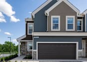 Thumbnail 27 of 44 - a home with a garage door in front of it at The Clearing at ONE28, Olathe, KS