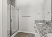 Thumbnail 32 of 36 - a bathroom with a sink and a walk in shower and a mirror at Hillcrest Village, Springdale, 72762