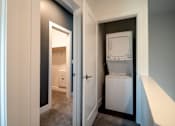 Thumbnail 6 of 18 - A white fridge is in a narrow hallway.