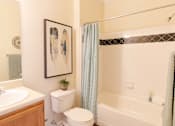 Thumbnail 37 of 44 - A bathroom with a toilet, sink, and bathtub. at The Crest at Sugarloaf, Lawrenceville, GA