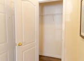 Thumbnail 30 of 44 - A white door with a gold handle is open to a white closet. at The Crest at Sugarloaf, Georgia, 30044