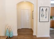 Thumbnail 29 of 44 - A hallway with a white door and a framed picture on the wall. at The Crest at Sugarloaf, Lawrenceville, 30044