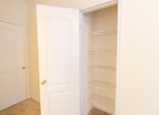 Thumbnail 26 of 44 - A white door is open to reveal a white pantry with empty shelves. at The Crest at Sugarloaf, Lawrenceville, Georgia