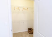 Thumbnail 25 of 44 - A white closet with a basket on the floor. at The Crest at Sugarloaf, Lawrenceville, 30044