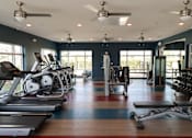 Thumbnail 21 of 33 - a gym with treadmills and other exercise equipment at The Crest at Laurel Canyon Apartments, Naples, Florida
