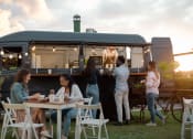 Thumbnail 51 of 60 - people eating at a table in front of a food truck at The Crest at South Point, McDonough, GA