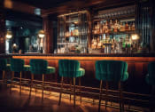 Thumbnail 57 of 66 - a bar with green bar stools in front of a bar at District at Riverside Apartments, Chattanooga