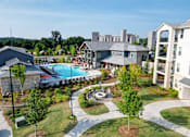 Thumbnail 13 of 30 - Aerial view of resortstyle pool and courtyard amenities at The Crest at Acworth Apartments, Georgia