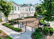 Thumbnail 15 of 30 - Fenced dog park with bench and landscaping at The Crest at Acworth Apartments, Acworth, 30102