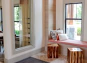 Thumbnail 17 of 27 - a window seat with a cushion and two wooden stools at The Crest at Laurel Canyon Apartments, Canton, GA, 30114