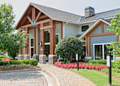 Thumbnail 16 of 27 - a home with a brick pathway leading to the front door at The Crest at Laurel Canyon Apartments, Canton