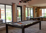Thumbnail 19 of 27 - a game room with a pool table and a ping pong table at The Crest at Laurel Canyon Apartments, Canton, Georgia