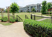 Thumbnail 11 of 27 - an apartment complex with a golf course in front of it at The Crest at Laurel Canyon Apartments, Canton, GA