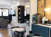 Thumbnail 17 of 30 - Community lounge with coffee bar and seating areas at The Crest at Acworth Apartments, Acworth, GA