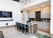 Thumbnail 19 of 30 - Open concept kitchen and living area with island seating at The Crest at Acworth Apartments, Georgia