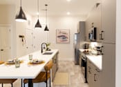 Thumbnail 3 of 66 - A modern kitchen with a dining table set for two.