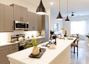 Thumbnail 4 of 66 - A modern kitchen with a white countertop and a black vase on it.
