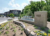 Thumbnail 5 of 72 - A sign that says District at Riverside stands in front of a building.