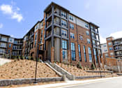 Thumbnail 24 of 53 - Apartment building with the number 215 on the front.