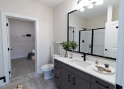 Thumbnail 49 of 66 - District at riverside brand new apartment community located in Chattanooga, TN apartment home bathroom with quartz countertops and walk in shower