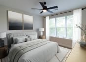 Thumbnail 48 of 66 - District at riverside apartment community bedroom with ceiling fan and large windows in Chattanooga, Tennessee