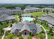 Thumbnail 10 of 27 - an aerial view of a large complex with a swimming pool and golf course at The Crest at Laurel Canyon Apartments, Canton, 30114