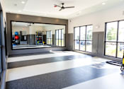 Thumbnail 21 of 30 - Fitness studio with mirrored wall and rubber flooring at The Crest at Acworth Apartments, Acworth, 30102