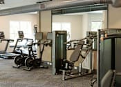 Thumbnail 36 of 66 - A gym with a variety of exercise equipment including treadmills, stationary bikes, and weight machines.at Riverside Apartments, Chattanooga, TN