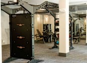 Thumbnail 32 of 66 - A gym with a black weight stack door.at Riverside Apartments, Chattanooga, 37406
