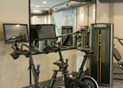 Thumbnail 34 of 66 - A row of stationary bikes are lined up in a gym.at Riverside Apartments, Chattanooga, Tennessee