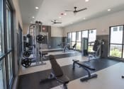 Thumbnail 24 of 54 - a gym with exercise equipment and windows in a building at The Crest at Acworth, Acworth, GA
