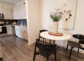 Thumbnail 4 of 54 - a kitchen with a table and chairs and a painting on the wall at The Crest at Acworth, Acworth