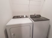 Thumbnail 9 of 54 - a washer and dryer in a white room with white walls and a white at The Crest at Acworth, Georgia, 30102