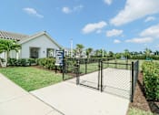 Thumbnail 14 of 33 - a fenced in yard with a house in the background at The Crest at Naples, Naples, Florida