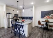 Thumbnail 11 of 54 - a kitchen with a bar and stools in front of a counter with a sink at The Crest at Acworth, Acworth