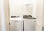 Thumbnail 8 of 30 - Laundry room with stacked washer and dryer at The Crest at Acworth Apartments, Acworth, 30102