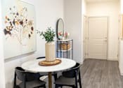 Thumbnail 4 of 30 - Dining area with round table and floral artwork at The Crest at Acworth Apartments, Acworth, 30102