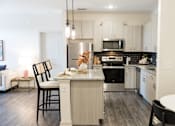 Thumbnail 1 of 30 - Modern kitchen with island seating and stainless appliances at The Crest at Acworth Apartments, Acworth, 30102