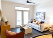 Thumbnail 2 of 30 - Living room with balcony access and modern furnishings at The Crest at Acworth Apartments, Acworth