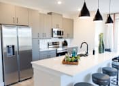 Thumbnail 12 of 66 - A modern kitchen with a stainless steel refrigerator and a white countertop.at Riverside Apartments, Chattanooga, Tennessee