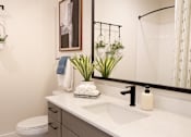 Thumbnail 22 of 66 - A bathroom with a white counter top and a white sink.at Riverside Apartments, Chattanooga, Tennessee
