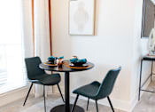 Thumbnail 15 of 66 - A dining table with two chairs and a bowl of blueberries on it.at Riverside Apartments, Tennessee, 37406