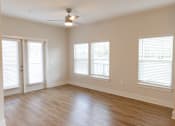 Thumbnail 27 of 27 - A room with a ceiling fan and three windows.