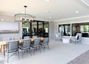 Thumbnail 9 of 27 - A modern dining room with a large table and chairs.