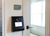 Thumbnail 14 of 27 - A package room sign is on a wall above a door.