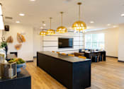 Thumbnail 6 of 72 - A modern kitchen with a black countertop and wooden floors.