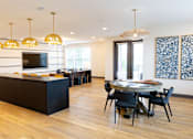 Thumbnail 7 of 72 - A modern dining room with a black table and chairs.