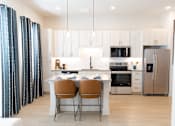 Thumbnail 1 of 53 - Cozy modern kitchen with Dinning table at District on the Etowah Apartments, Canton, GA 30114